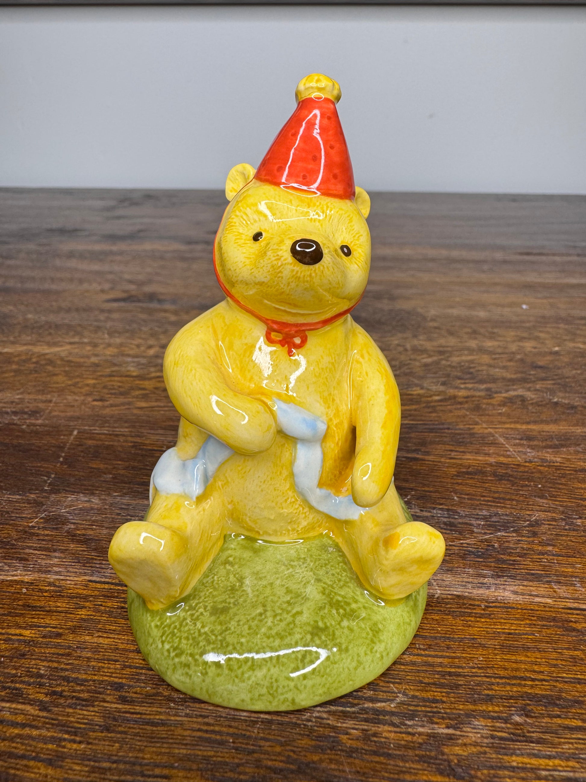 Royal Doulton Winnie the Pooh in A Party Hat Figurine