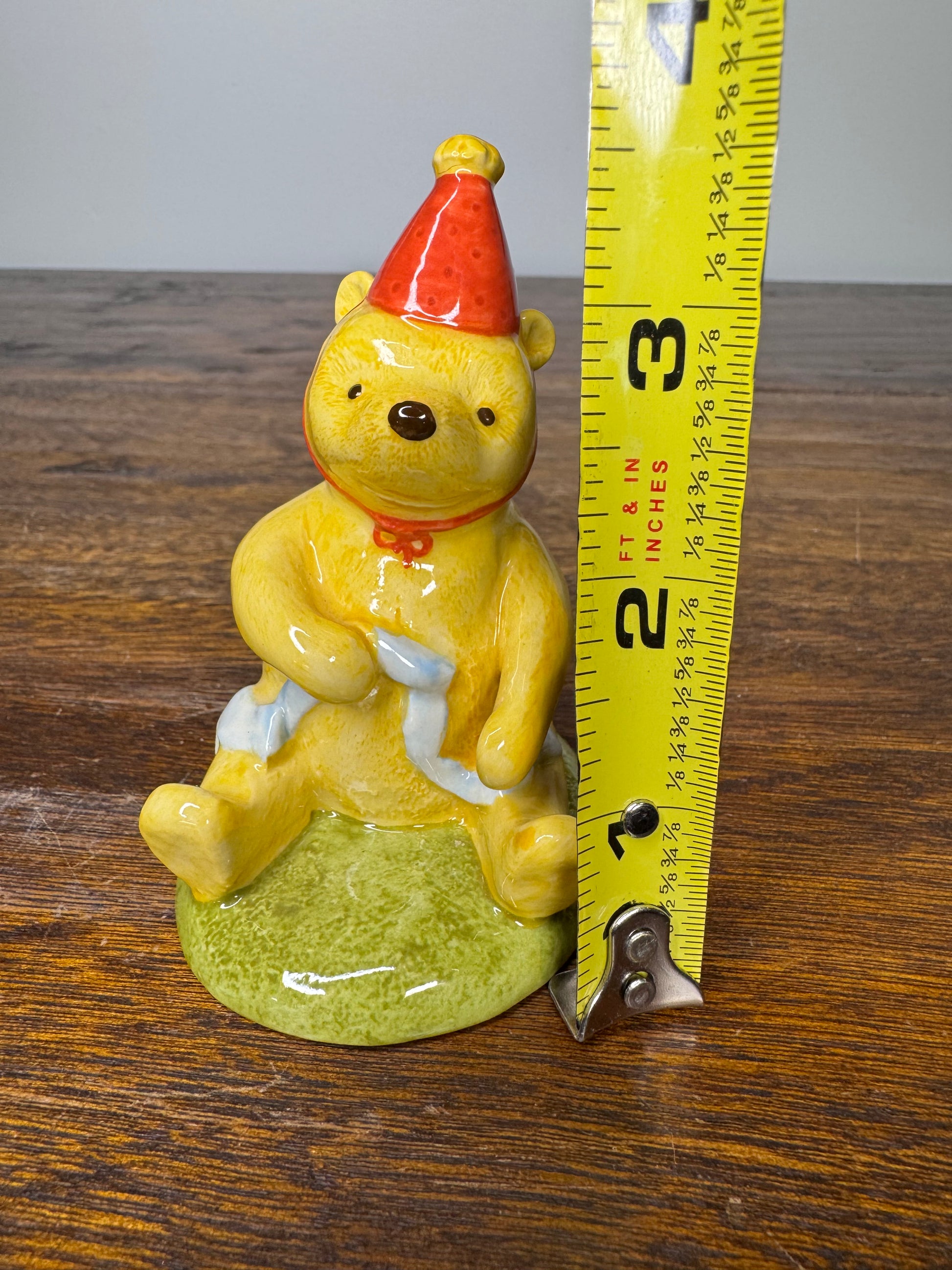 Royal Doulton Winnie the Pooh in A Party Hat Figurine