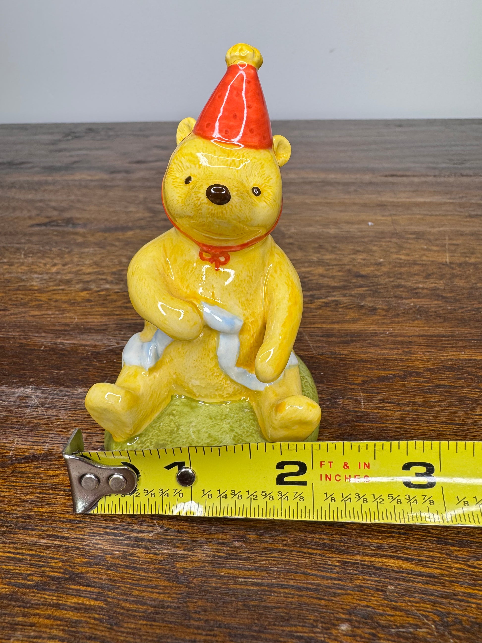 Royal Doulton Winnie the Pooh in A Party Hat Figurine